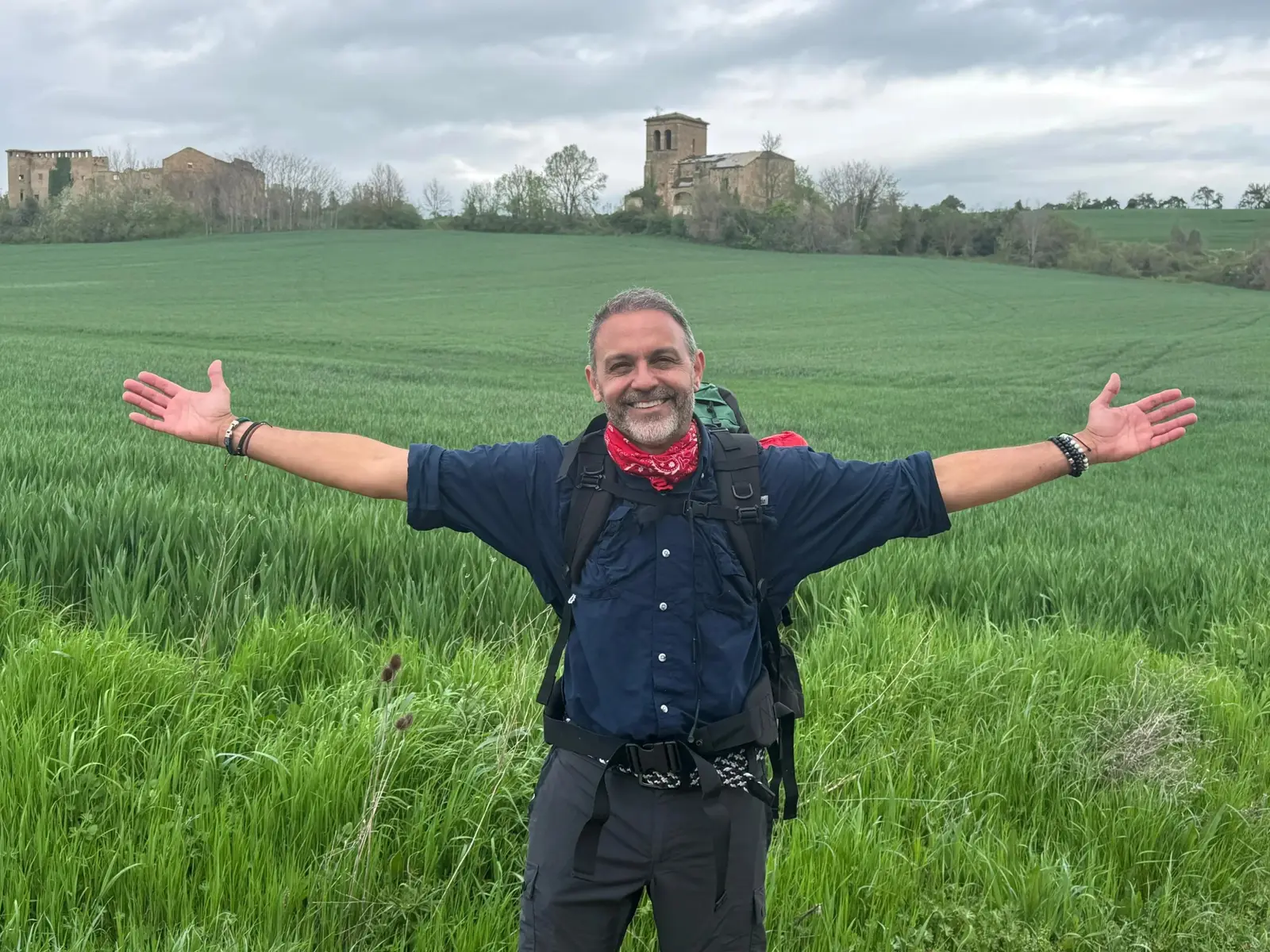 Alejandro Pérez Bolaños con los brazos abiertos en un campo verde